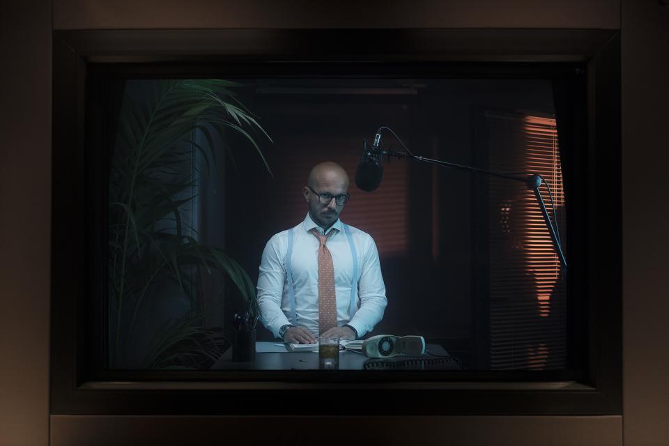 Red light frames the glass.
The booth never changes.
Same microphone. Same walls. Same air.
But each podcast reshapes the room into a different world.
Here, tie tightened, notes aligned — a business podcast begins.
HYPERCAST — one space, infinite strategies.